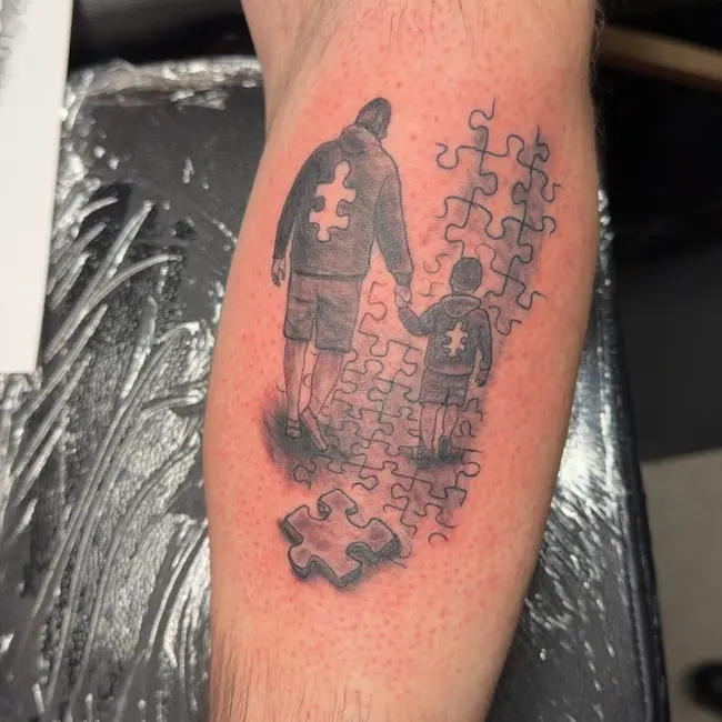 Father & son black and grey puzzle piece tattoo